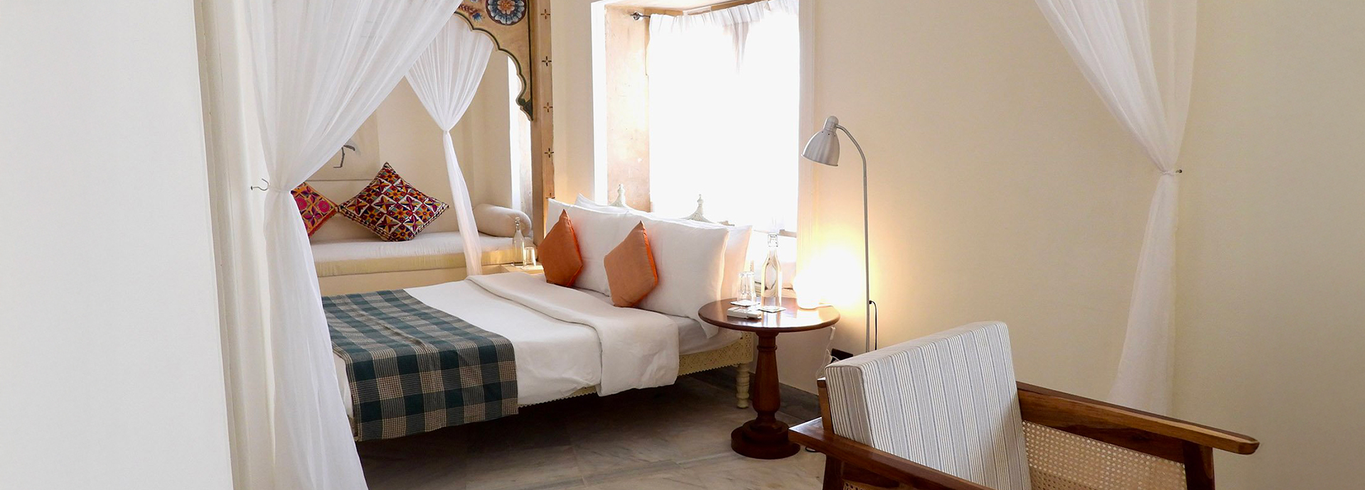 Spacious suite at The Stepwell House with soft natural lighting and classic furnishings.
