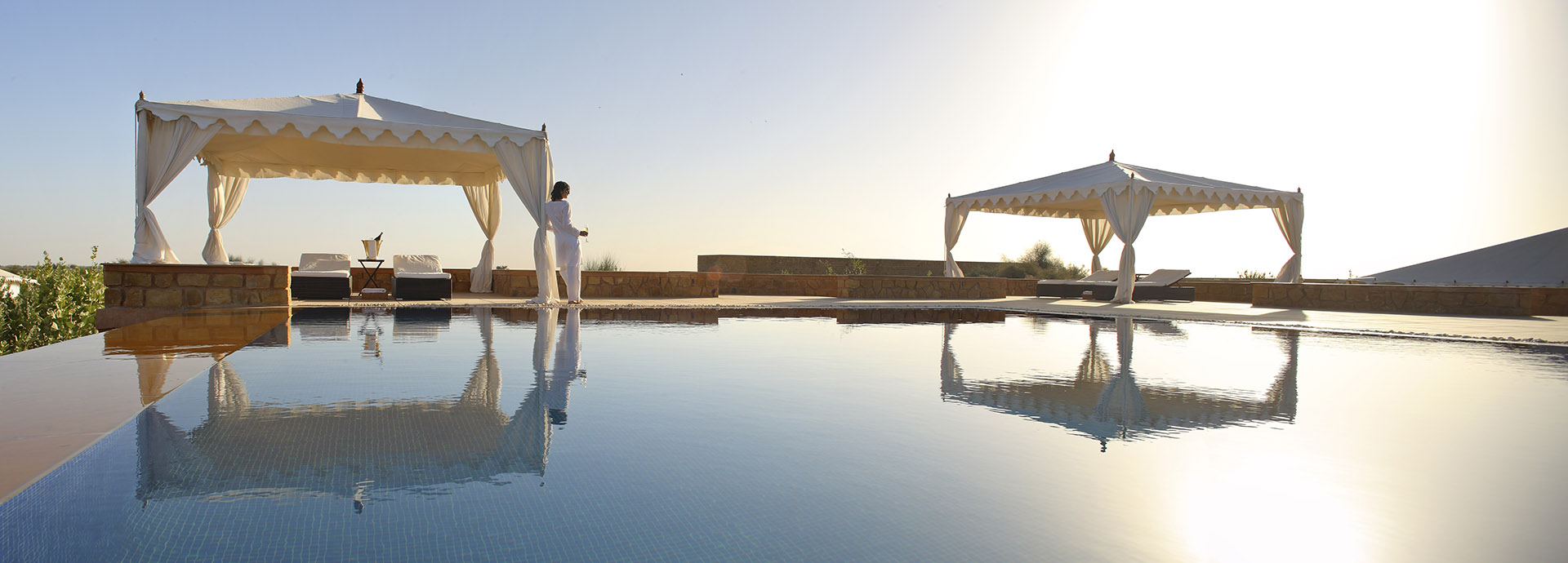 The spectacular swimming pool at Sujan's The Seria outside Jaisalmer contrasts with the surrounding desert landscape.