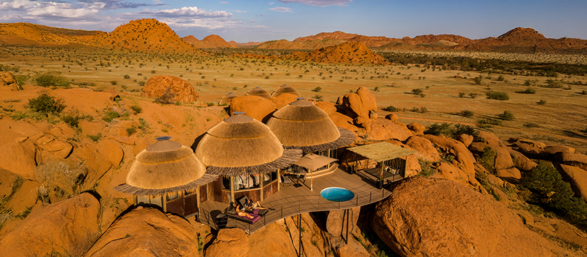 Aerial view of the stunning Camp Kipwe, nestled amongst the large red-rock boulders of Damaraland