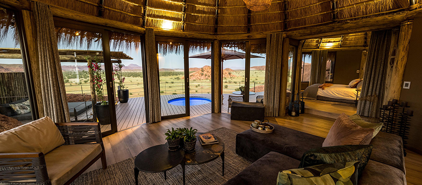 Camp Kipwe private suite with a view over a private plunge pool to the landscapes of Damaraland, Namibia