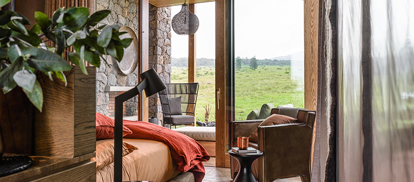 Chic, contemporary interior of suite with views of Volcanoes National Park at Kataza House, Rwanda