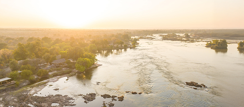 Aerial view of Toka Leya Camp along the Zambezi River at sunrise