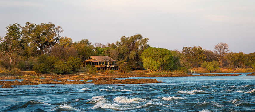 Toka Leya tented suite viewed across the Zambezi’s rocky channel