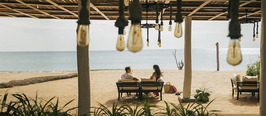 Couple enjoy a romantic drink on a Sri Lankan beach