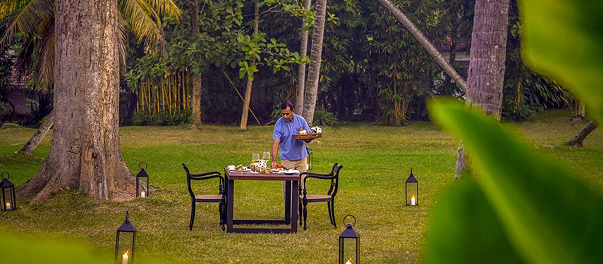 Waiter serves breakfast at a luxurious colonial-style hotel in Sri Lanka