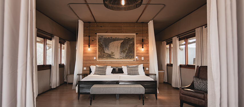 Elegant bedroom interior of a luxury tent at Toka Leya Camp
