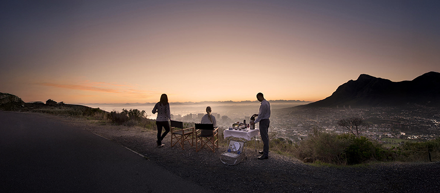 People enjoying a sunset picnic overlooking Cape Town