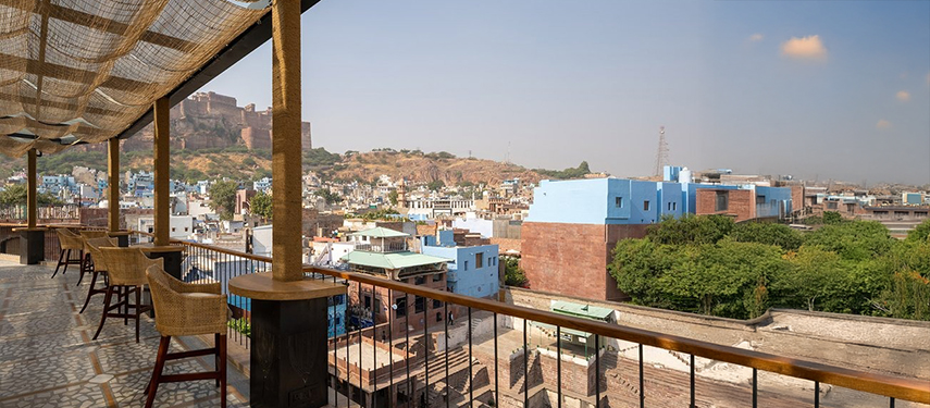 Rooftop terrace at The Stepwell House overlooking the blue cityscape of Jodhpur.