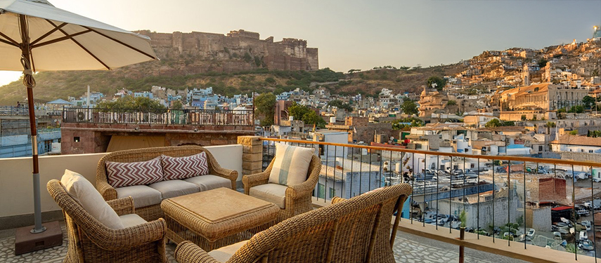 Relaxed rooftop seating at The Stepwell House overlooking Jodhpur’s old city and fort.