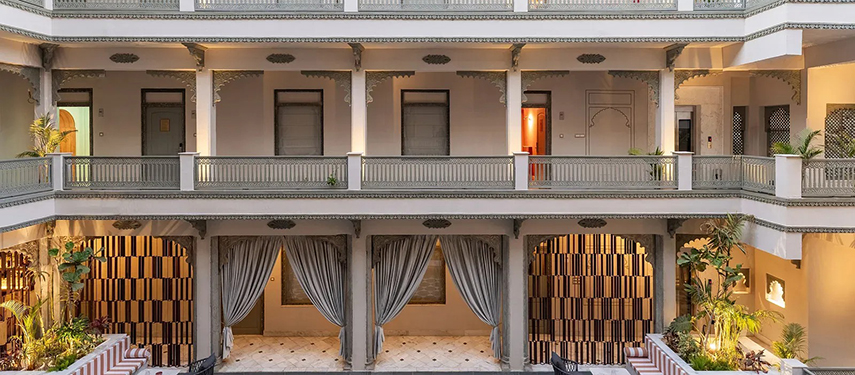 Exterior view of symmetrical multi-level balcony design at Jhilwara Haveli