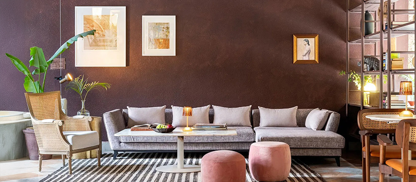 Chic lounge space with velvet sofa, pastel accents, and curated artwork