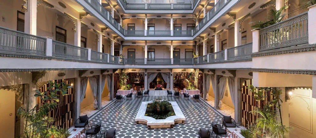 Ornate open-air courtyard with central water feature and three levels of arched walkways
