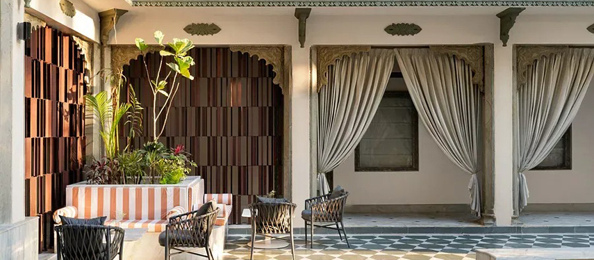 Cosy courtyard corner with draped archways and potted plants