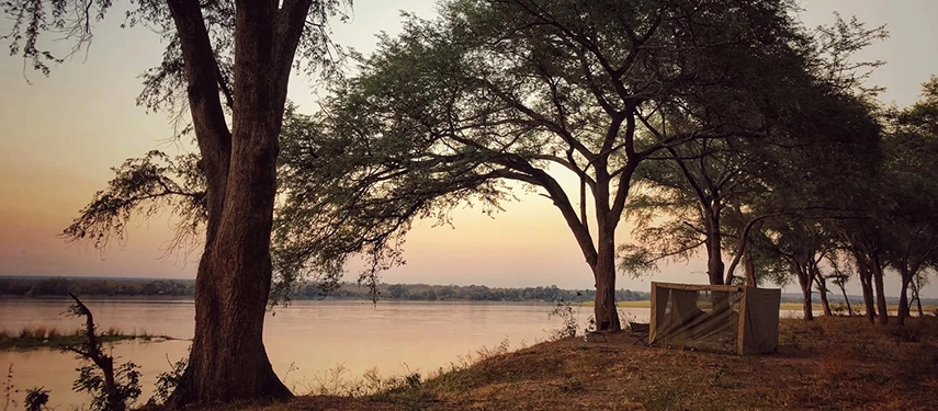 Safari tent overlooking the wide expanse of the Zambezi River at Kutali Camp.