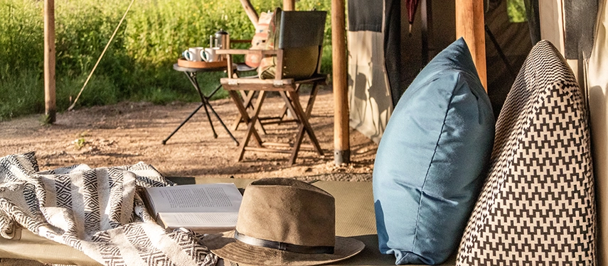 Sun loungers outside the tented suites at Nyasi Tented Camp provide a quiet space to relax while overlooking the open Serengeti plains.