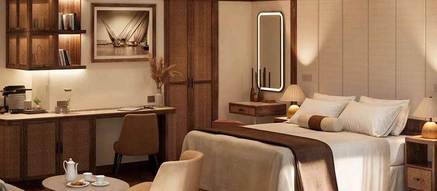 A refined river-facing suite aboard A&K Sanctuary Nile Seray with neutral tones, woven textures and large windows overlooking the Nile.